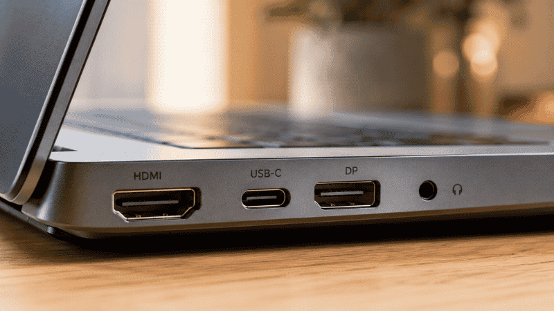 Close-up of laptop ports showing HDMI, USB-C, and DisplayPort connections used for dual monitor setup