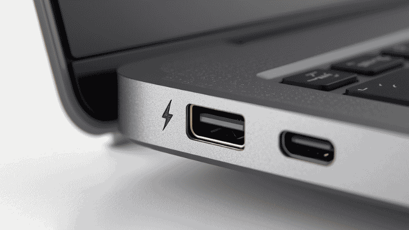 Close-up of a laptop USB-C port with a Thunderbolt lightning bolt symbol indicating Thunderbolt compatibility