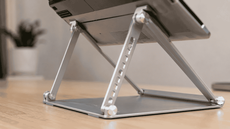 Close-up of adjustable laptop stand height adjustment mechanism showing multiple height positions available for ergonomic customization
