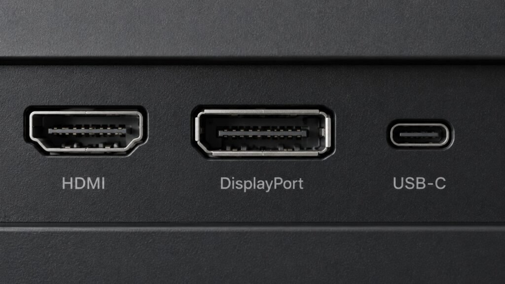 Close-up of computer ports showing HDMI, DisplayPort, and USB-C connectors labeled for dual monitor setup connection